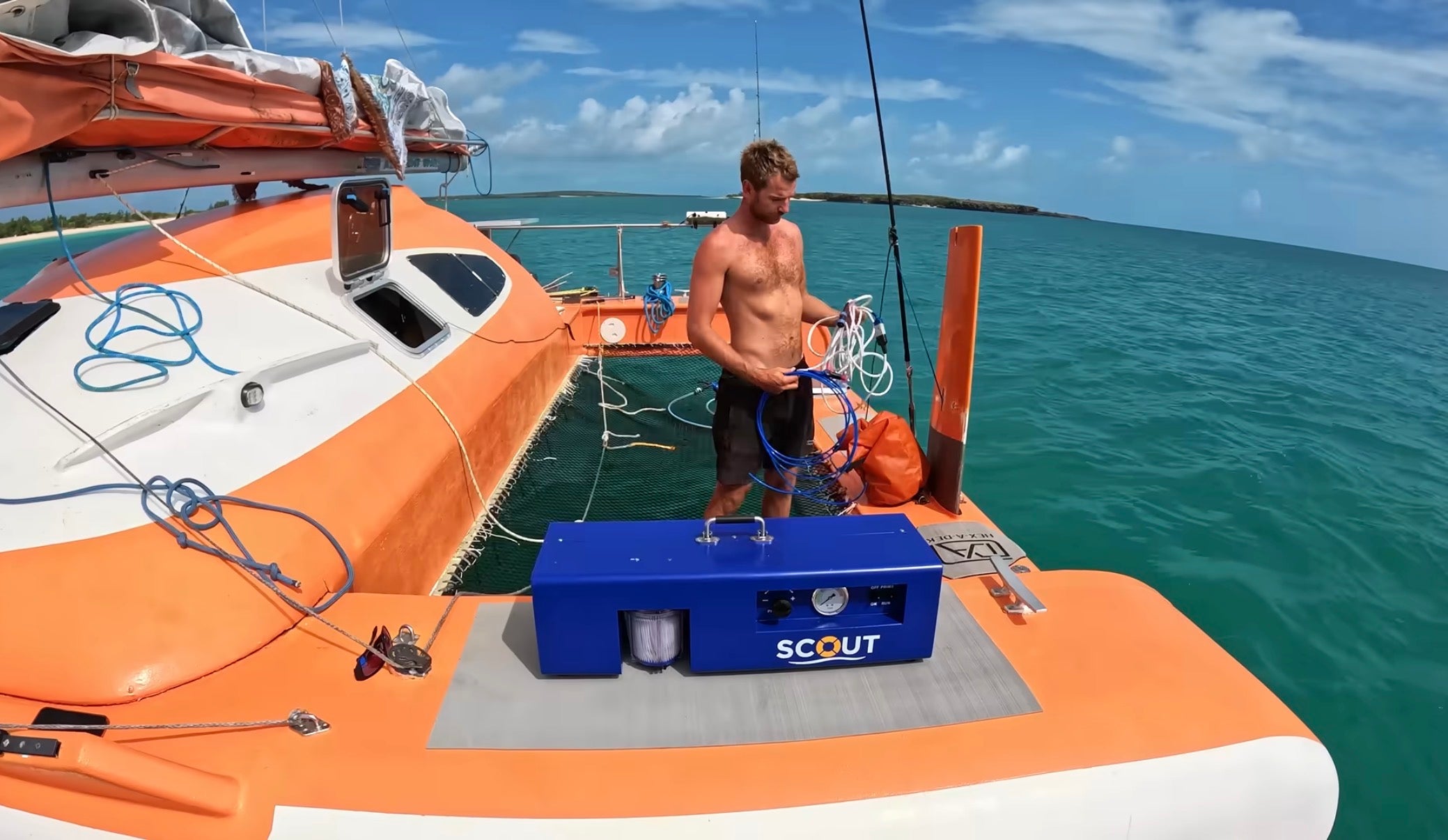 LEDI Scout DIY watermaker for boat in use on a catamaran with turquoise water and island behind